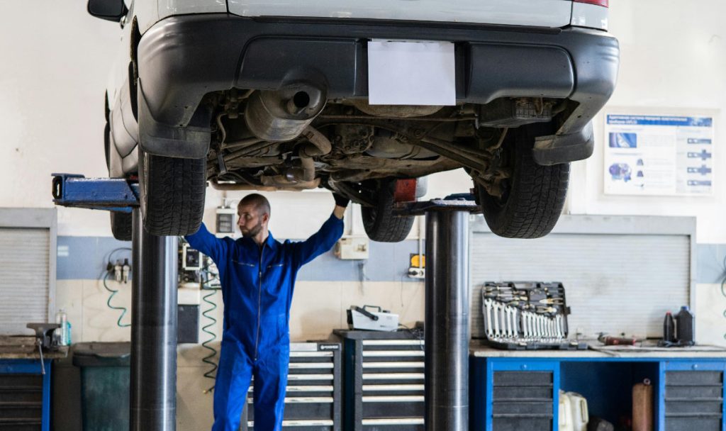 An automechanic performing a vehicle inspection.