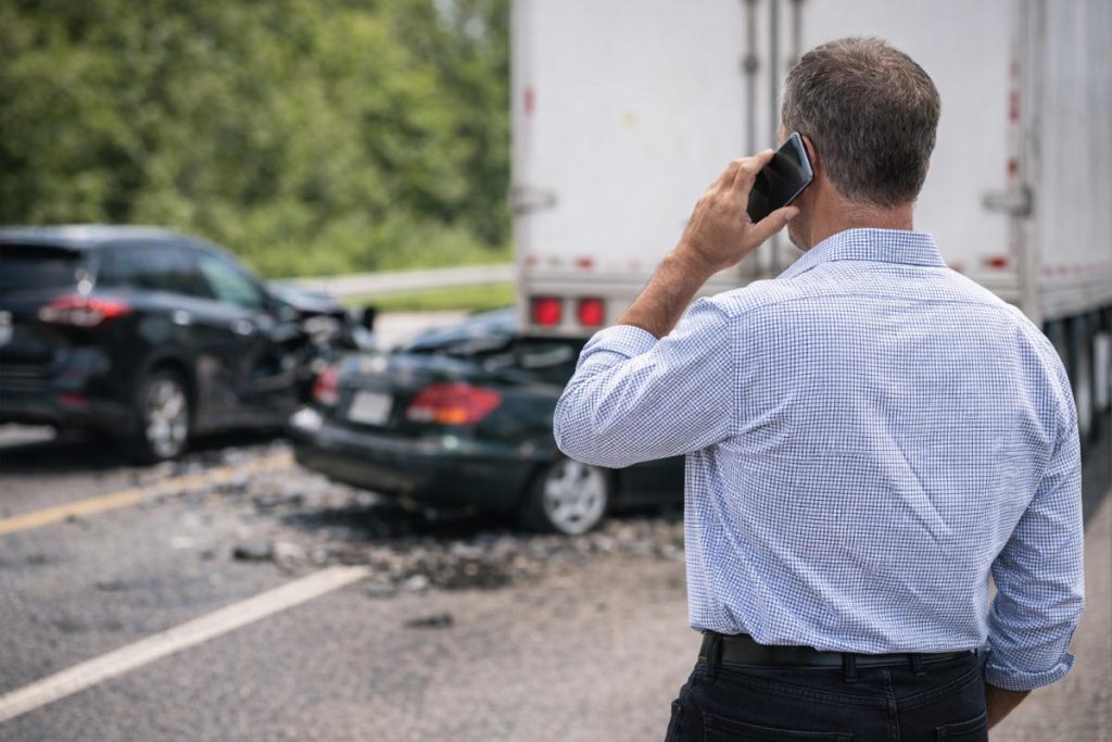 Truck accident victim calling attorney after accident.